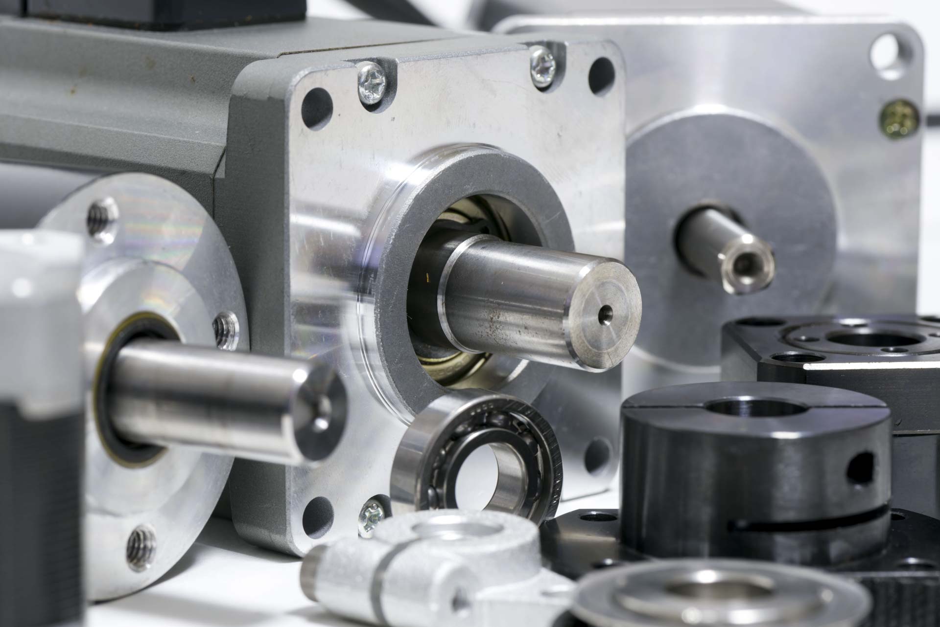 Nahaufnahme mehrerer Aluminium-Getriebemotoren mit Antriebswellen und Kugellagern